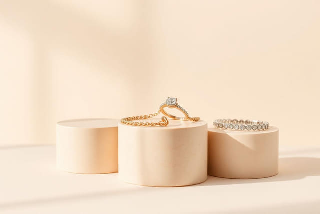 Gold necklace, diamond ring and silver bracelet on display