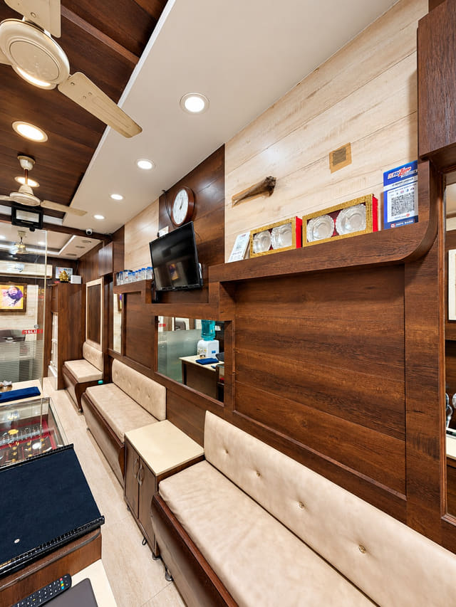 Wood-panelled showroom and cream seating